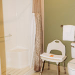 ADA accessible bathroom with shower and seat