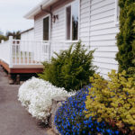 side exterior of Pacific Inn with flowers